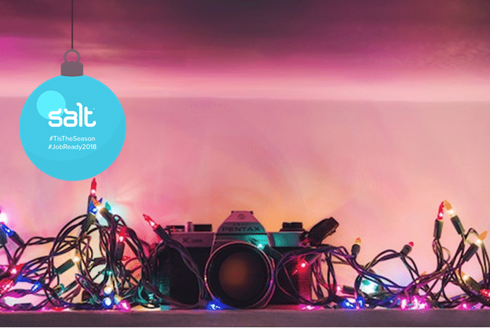 camera surrounded by christmas fairy lights
