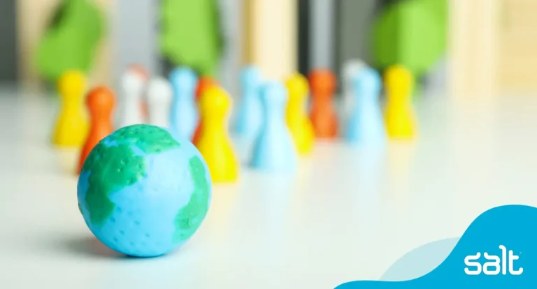 Globe and figurines illustrating the concept of a globally diverse team in remote recruitment.