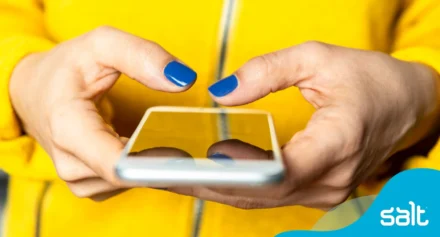 Close up of someone using their phone in both hands.