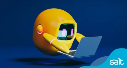 Yellow animated robot reading on a laptop.