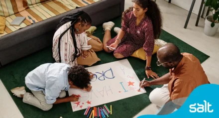A family drawing a poster with the words "I have a dream".
