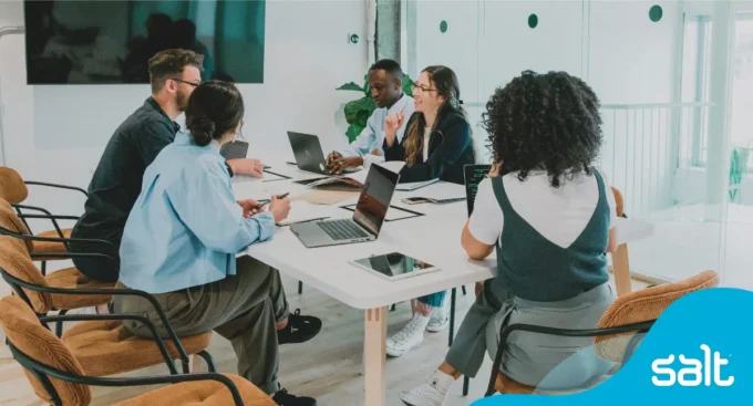 Group of people sat in a office boardroom meeting
