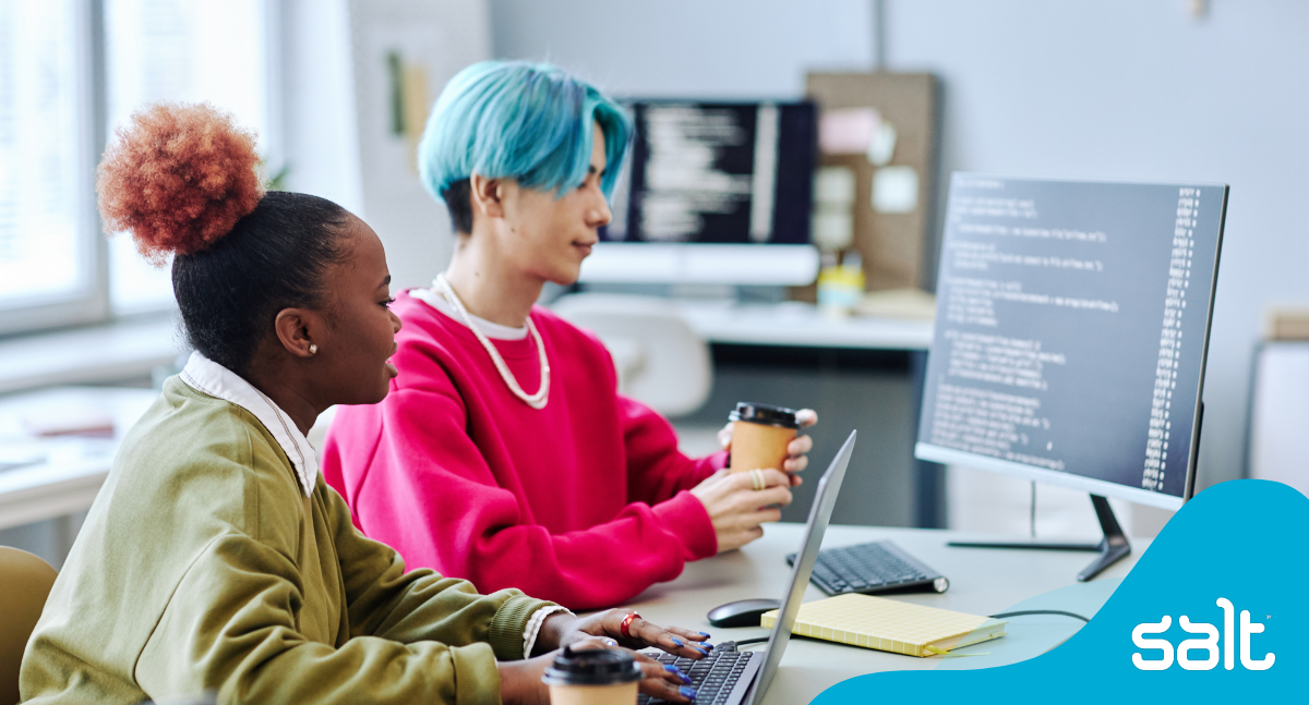 Two diverse professionals collaborating in an office, reflecting teamwork in data or digital design recruitment fields for Salt