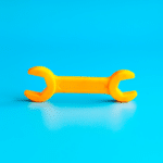 plastic yellow wrench on a blue background to symbolize a skills-based hiring approach