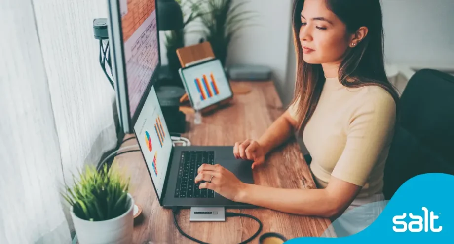 Unleashing the power of skills: how skills-based hiring changes your recruitment game 1 Woman sitting at a desk analysing data on digital devices.