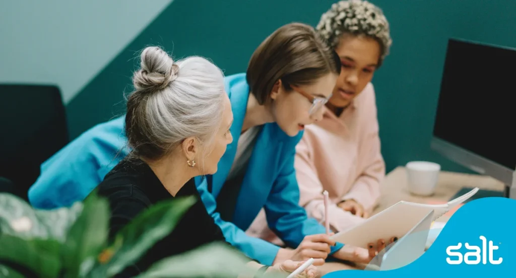 Essential AI talent report 2 Three female colleague’s looking at something on a paper together