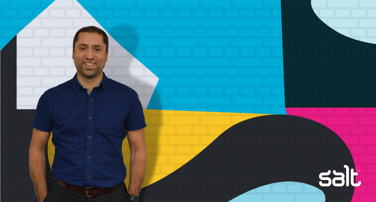Dom Selvon, CTO of Apply Digital, standing in front of Salt's wall