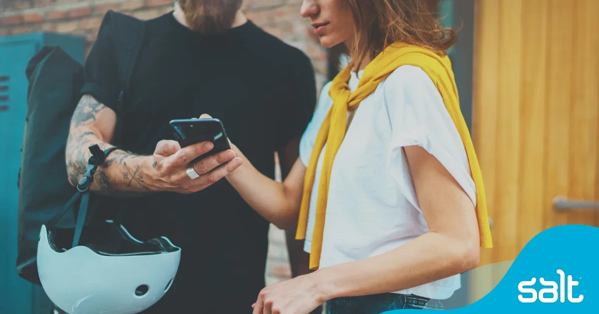 Two people looking at a phone