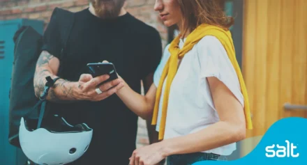 Two people looking at a phone.