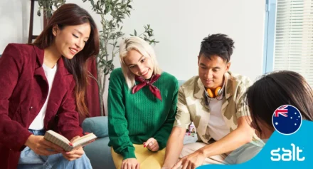 Four diverse young professionals in a work environment.