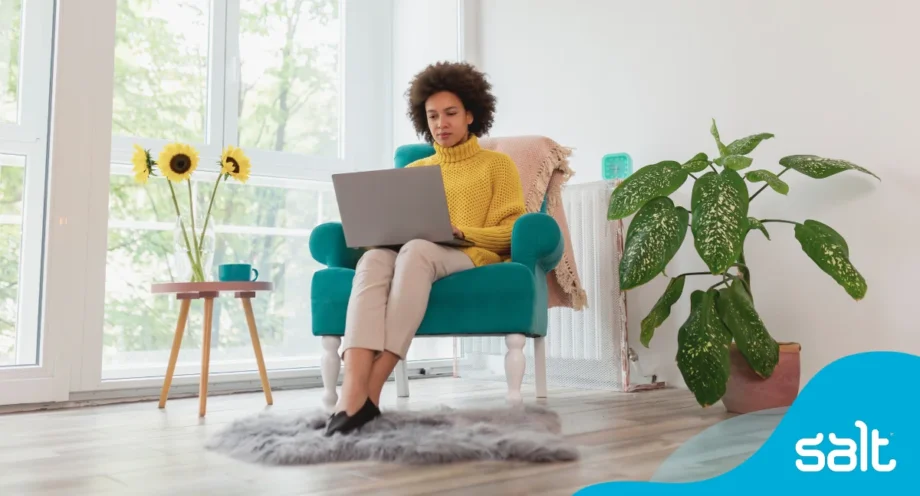 12 of the best apps for freelancers: grow and manage your business 1 A woman sitting in a chair using a laptop.