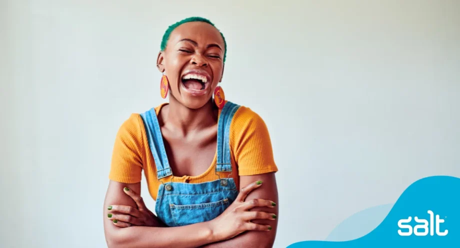 9 helpful ways to market yourself for your next marketing role 1 Woman proudly smiling wearing yellow shirt and dungarees