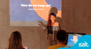 A women stood in front of a presentation with the words 'how do we keep up?'