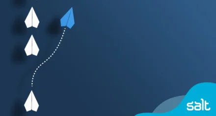 Blue paper plane breaking away from a group of white planes, symbolising innovative leadership in the digital era