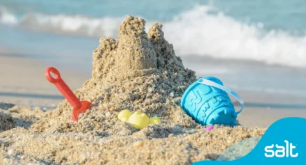 Sandcastle on the beach with waves approacing