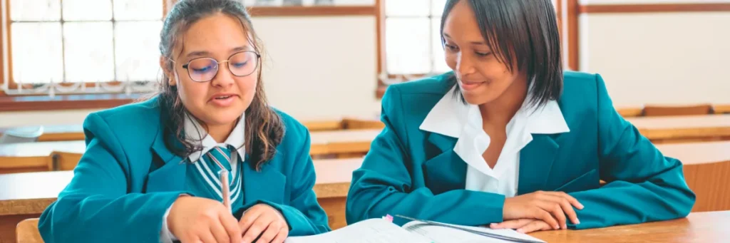 Salt South Africa's journey with the Spirit Education Foundation 2 Spirit Education Foundation learners sitting at a school desk.