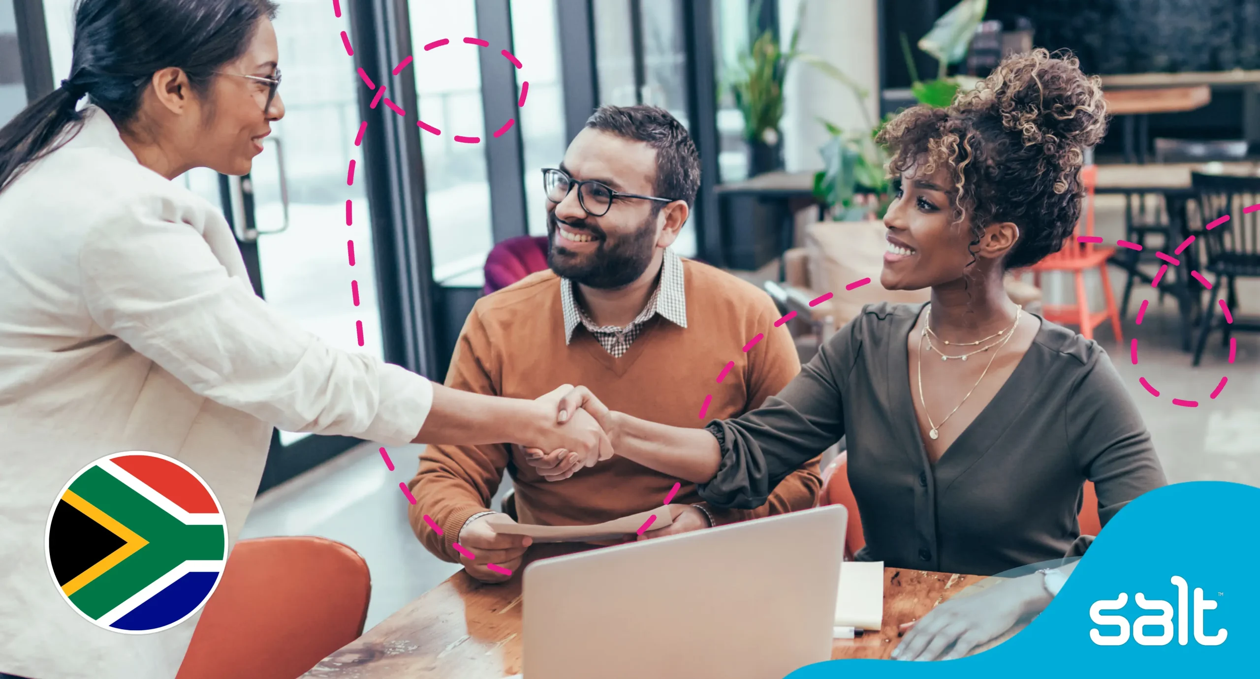 Professional meeting in modern office setting with diverse colleagues shaking hands. Smiling Black woman and South Asian man engage positively with businesswoman in white blazer. South African flag and Salt recruitment agency branding indicate focus on career advice and ui/ux industry job opportunities in South Africa.