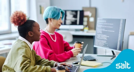 Two diverse professionals collaborating in an office, reflecting teamwork in digital marketing recruitment fields for Salt article