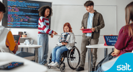 A group of young students looking at tech