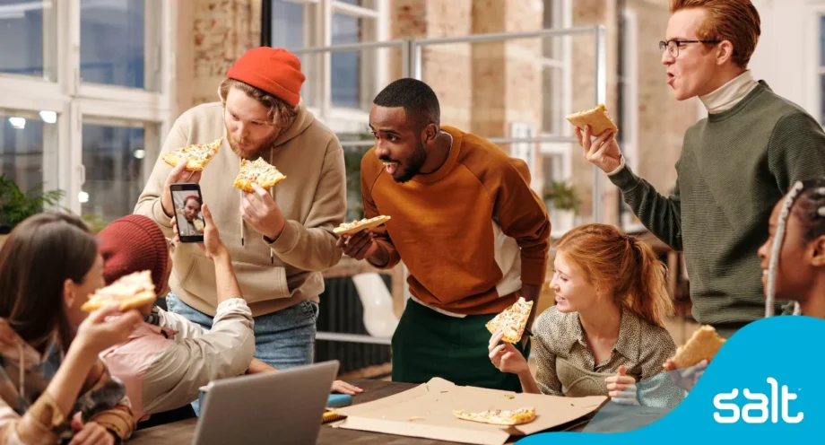 Why company culture matters when hiring (it’s more than just pizza parties) 1 Team of people cheering with slices of pizza looking happy