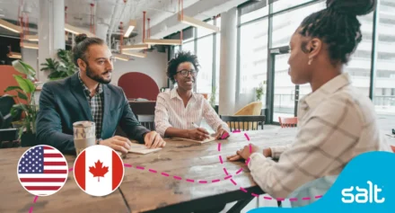 People in the office witha US and Canada flag to the left