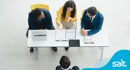 A group of interviewers talking to a interviewee