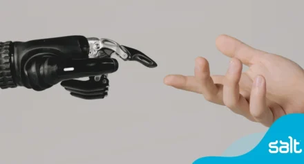 Robot hand and human hand reaching out to each other