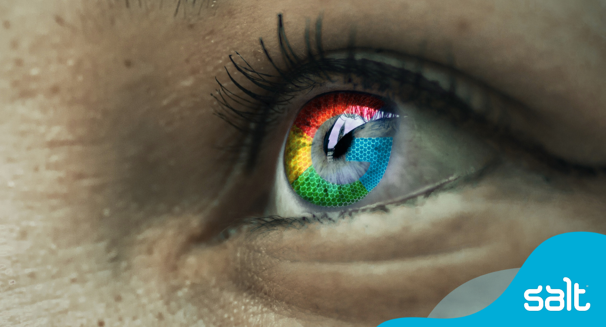 A close up of the eye of a person reflecting the google logo