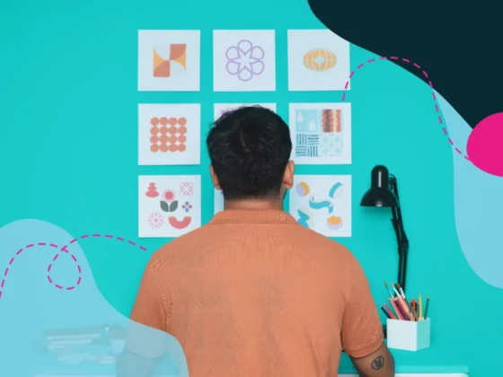 Man sitting at a desk looking at abstract artwork on a wall