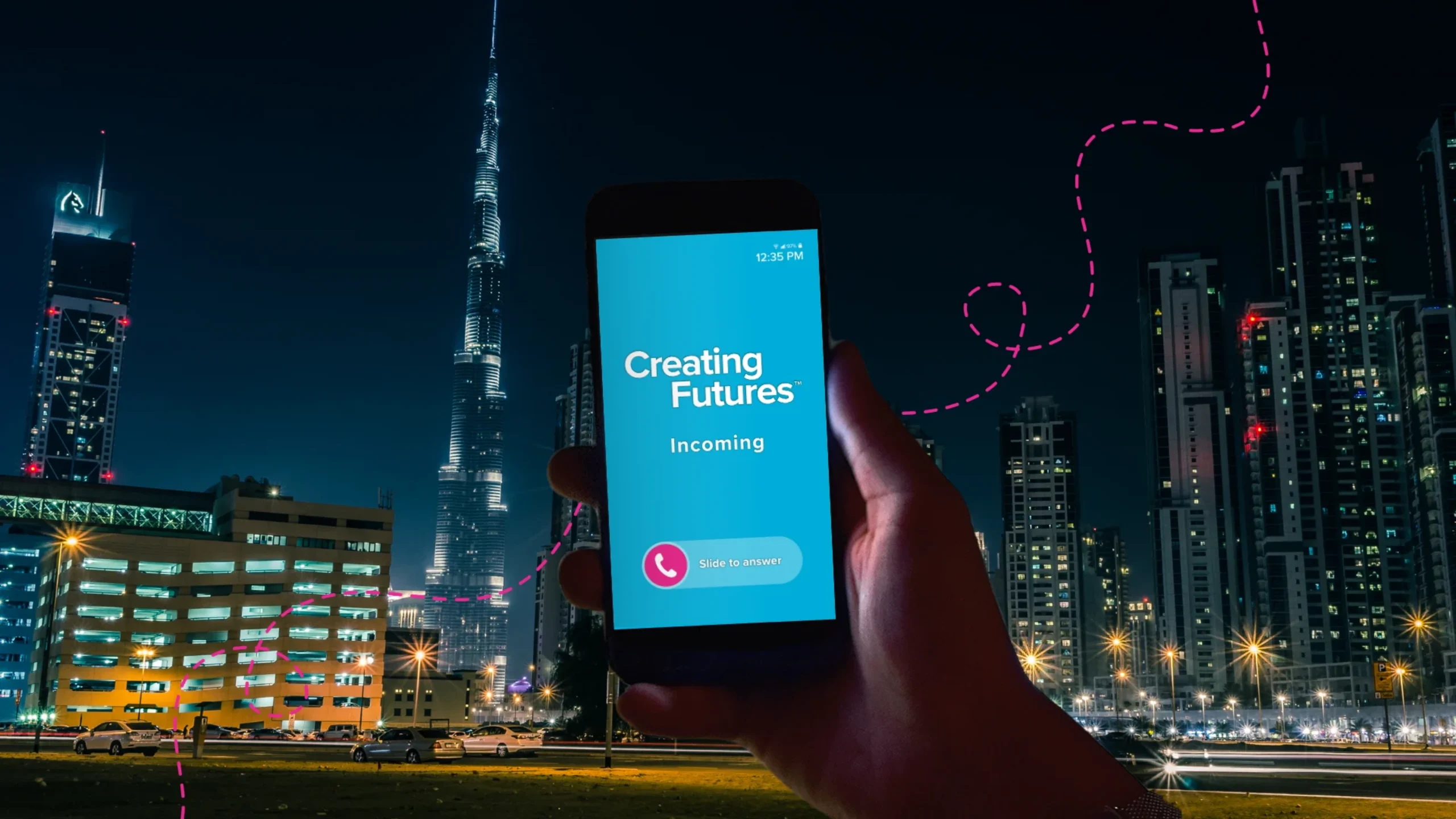 a hand holding a phone with a blue screen in the UAE