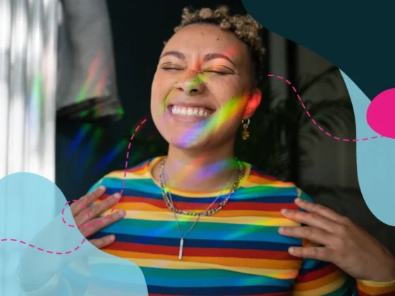A woman smiling confidently, representing pride in diversity and inclusion