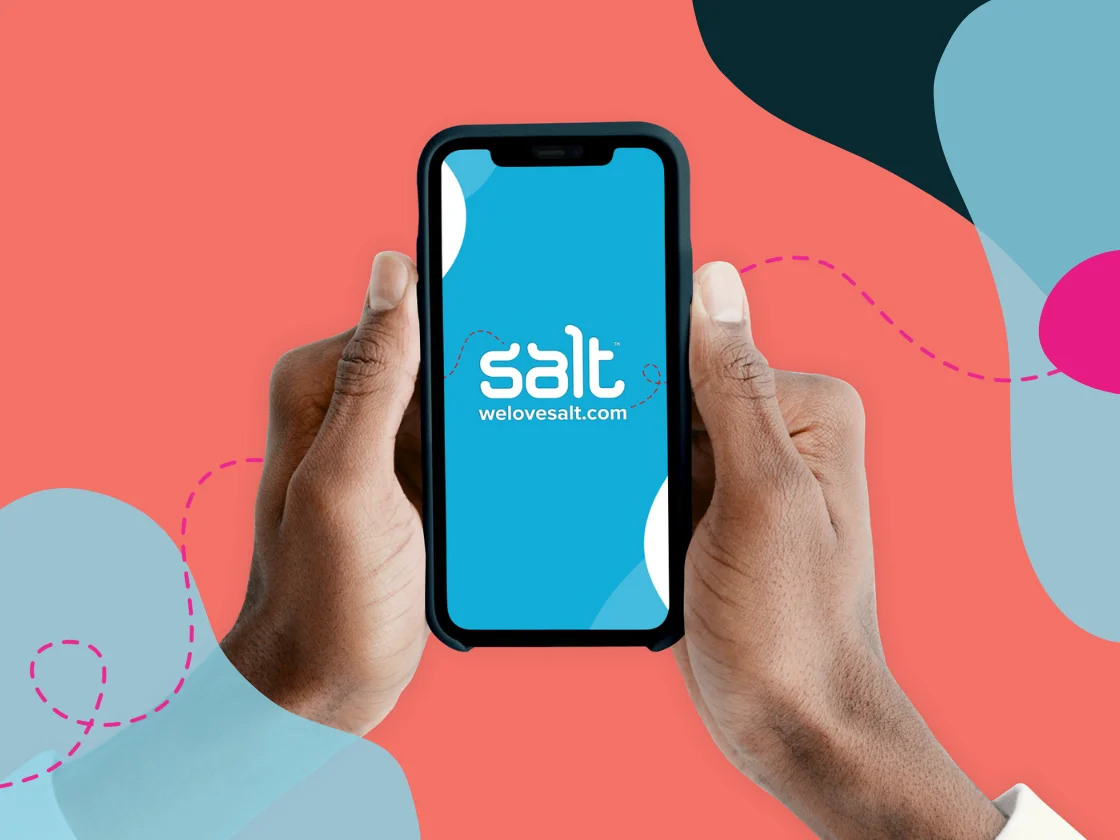 A smartphone being held in two hands with Salt logo and welovesalt.com visible on the screen