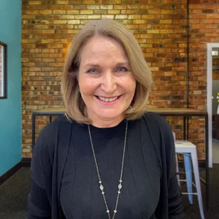 Ann Harman headshot in a Salt office