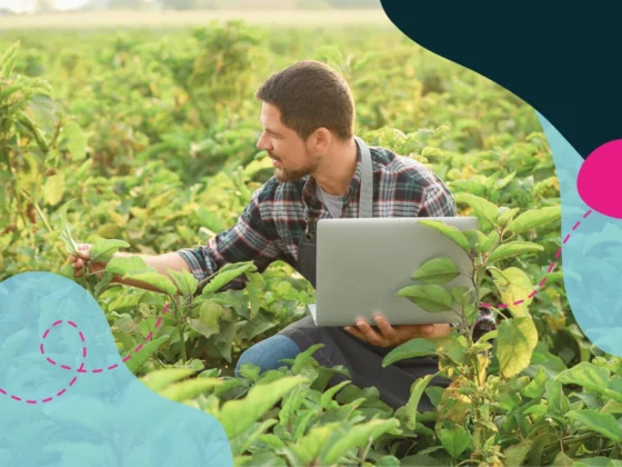 Man looking at plants and analysing them on the computer.