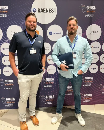 Two men wearing Salt-branded gear pose in front of a backdrop at the Africa Tech Summit in Nairobi.