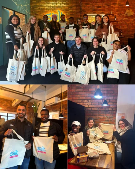 Team members proudly hold Salt-branded tote bags during a donation drive for the Spirit Foundation and She Matters initiative.
