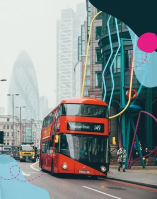 A red double-decker bus labeled 'Edmonton Green 149' drives through a foggy London street, surrounded by modern buildings and colourful art
