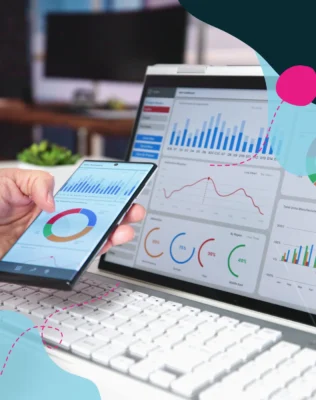 a hand holding a phone and looking at a screen both devices with data on screen