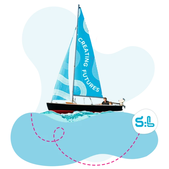 Man steering a sailboat with the the words "Creating Futures" on the sail