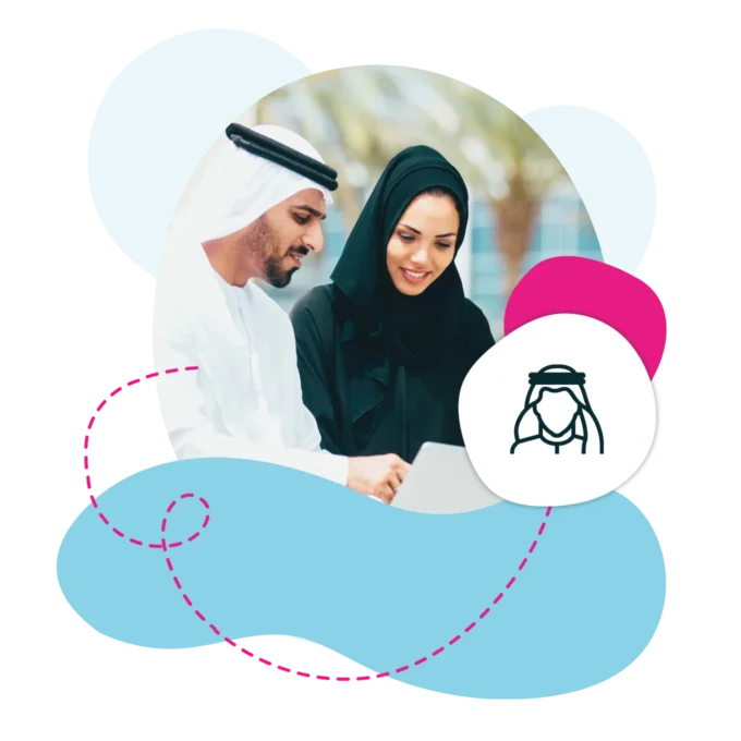 Emirati male and female working on a laptop outside.