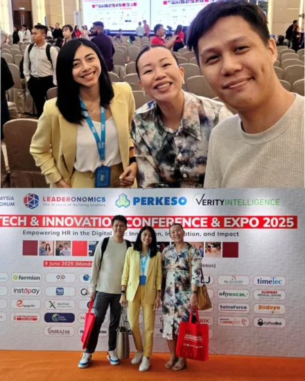 Three attendees at the HR Tech & Innovation Conference & Expo 2025 in Malaysia — smiling together inside the conference hall and posing in front of the official event backdrop.