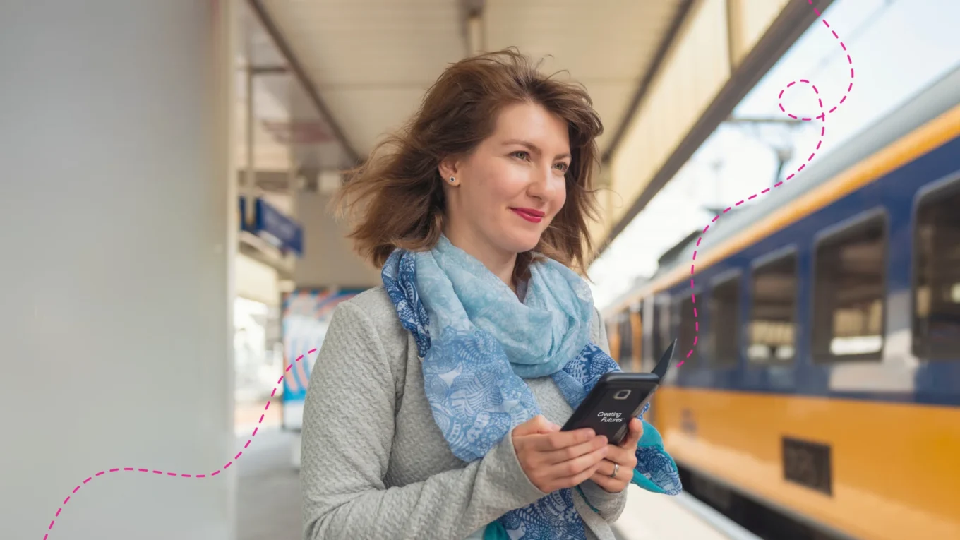 Woman on her phone at a Dutch train station.