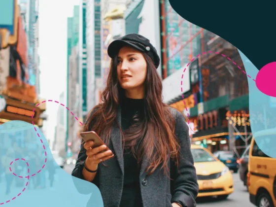 Woman walking in New York street with her phone in hand.