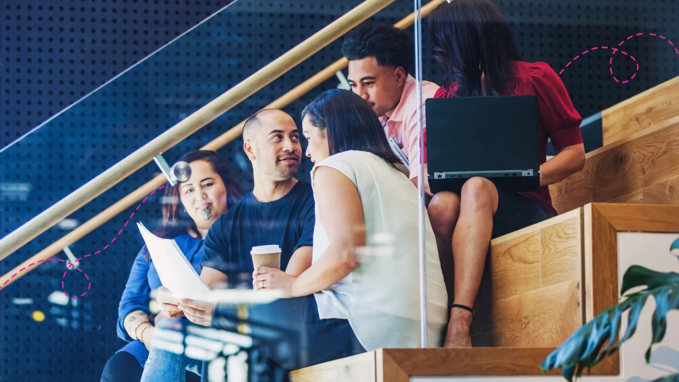 Team of Maori coworkers sitting in stairs having a casual meeting
