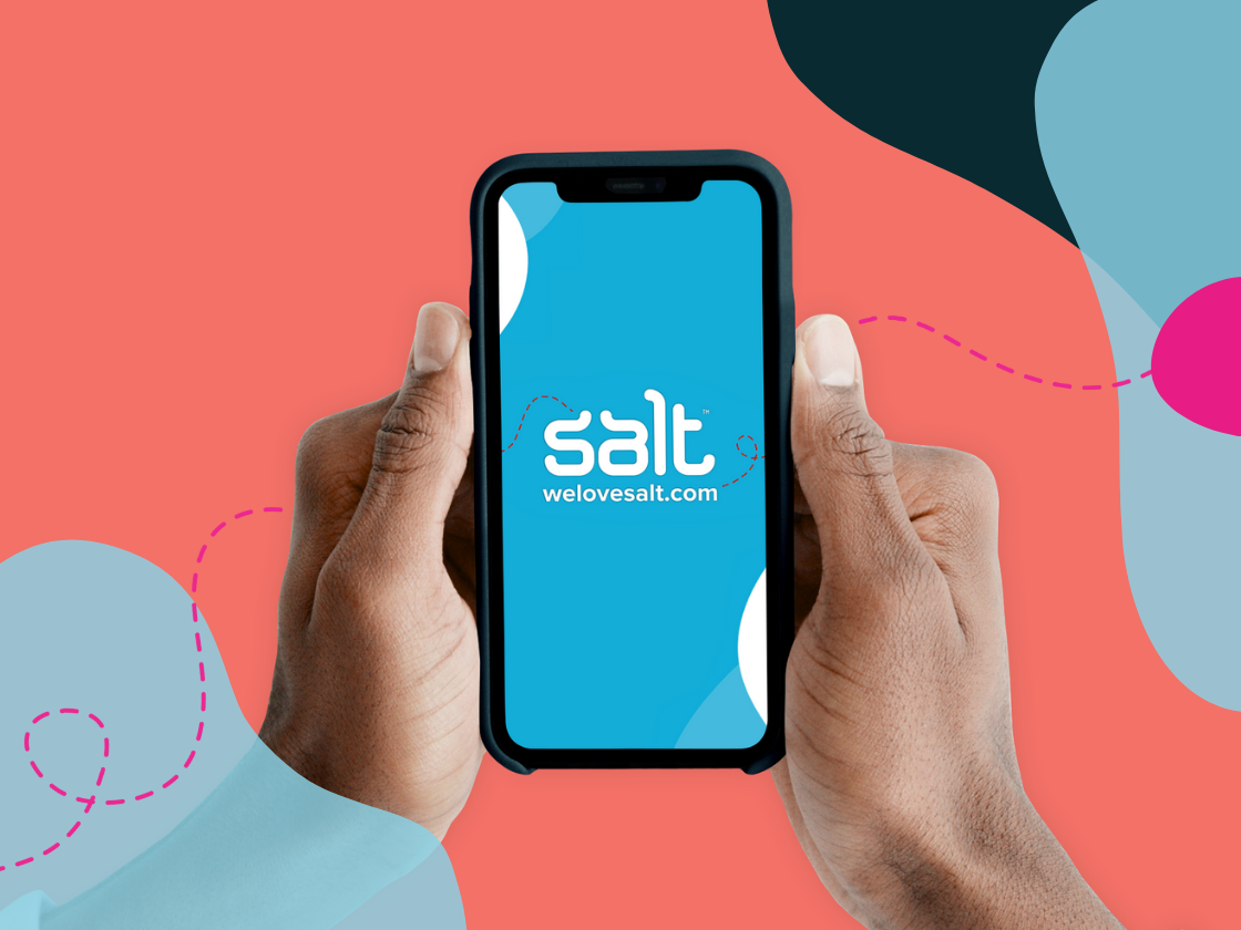 A smartphone being held in two hands with Salt logo and welovesalt.com visible on the screen