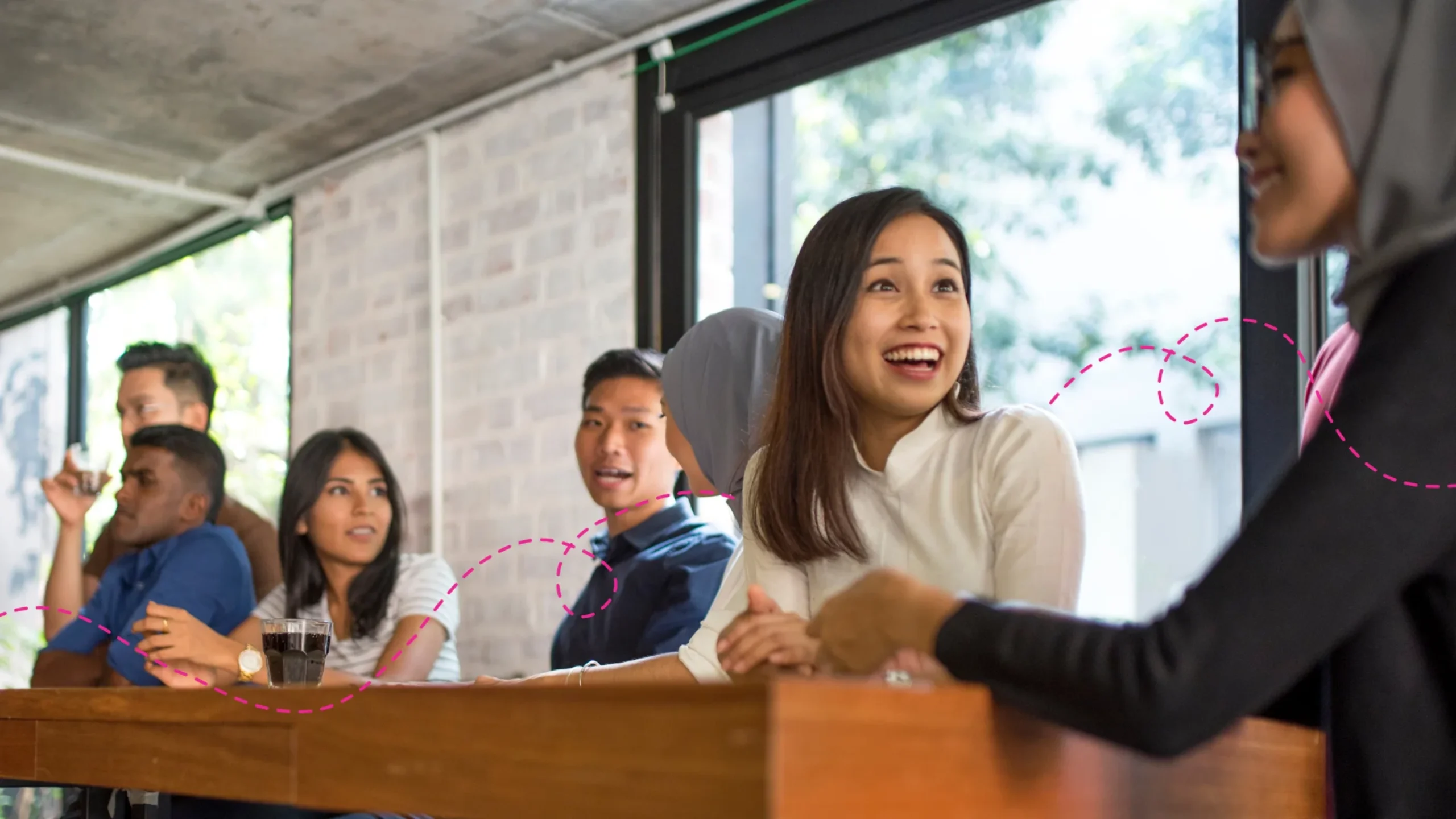 Work team sitting together at a lunch desk