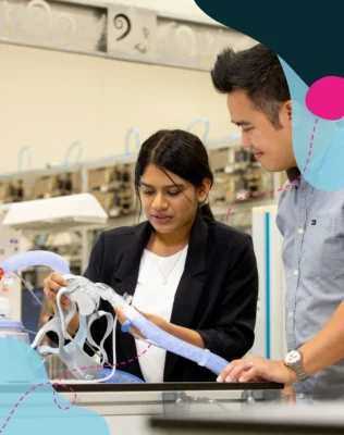 Two people working on medical equipment