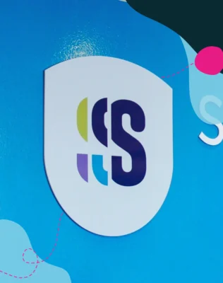 Skills Group logo branding on a blue wall