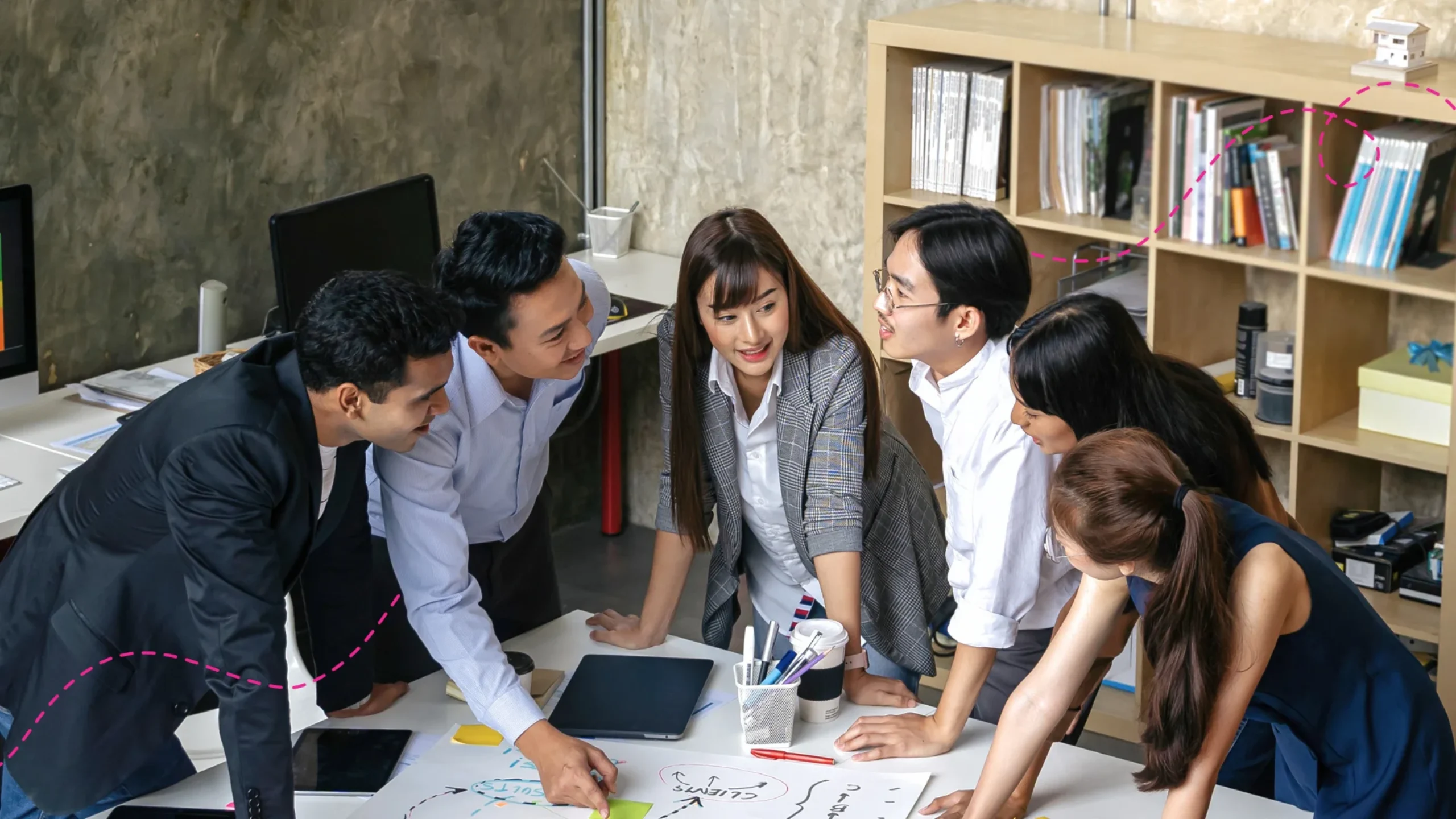 Group of people brainstorming at an office desk