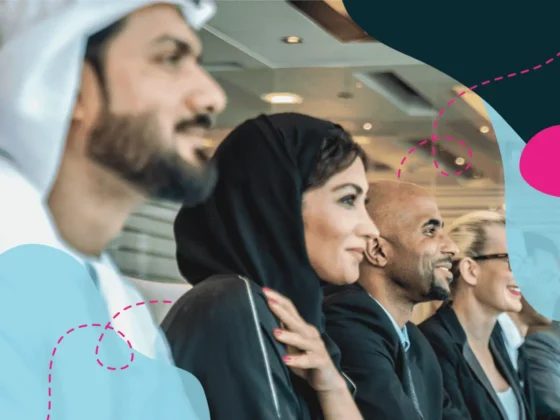 Emirati colleagues at a boardroom meeting table.